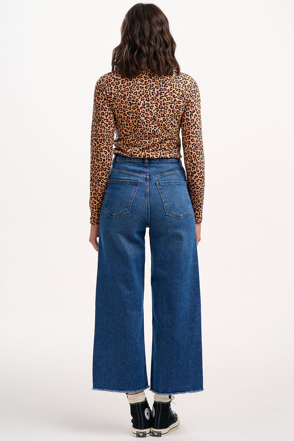 Sugarhill Brighton - Person wearing a leopard print top and blue jeans on a white background