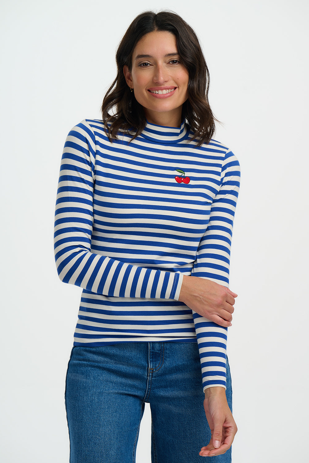 Woman wearing a blue and white striped shirt with a red heart emblem on a white background