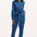 Woman wearing a blue denim jumpsuit with star pattern on a white background