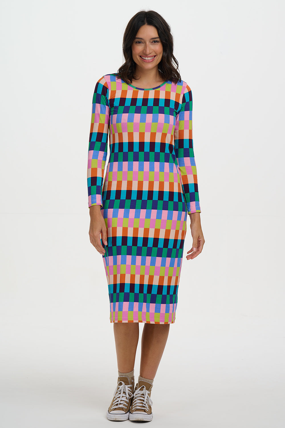 Woman wearing a colorful checkered dress on a white background