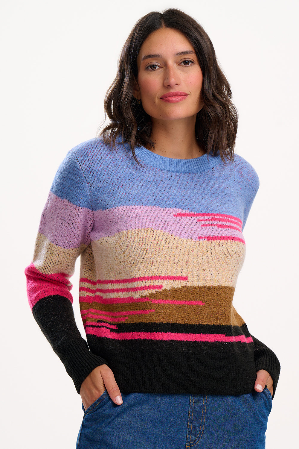 Woman wearing a colorful striped sweater on a white background