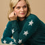 model wearing a teal sparkle jumper with stars on 
