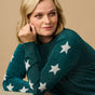 model wearing a teal sparkle jumper with stars on 