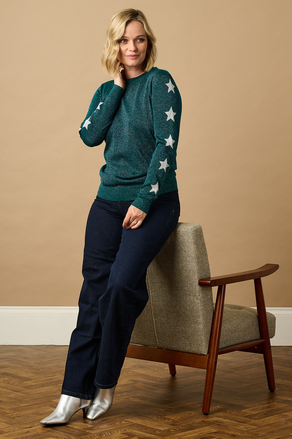 model wearing a teal sparkle jumper with stars on 