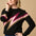 A female model wearing a black, berry and biscuit colored jumper with a crew neck and long sleeves.