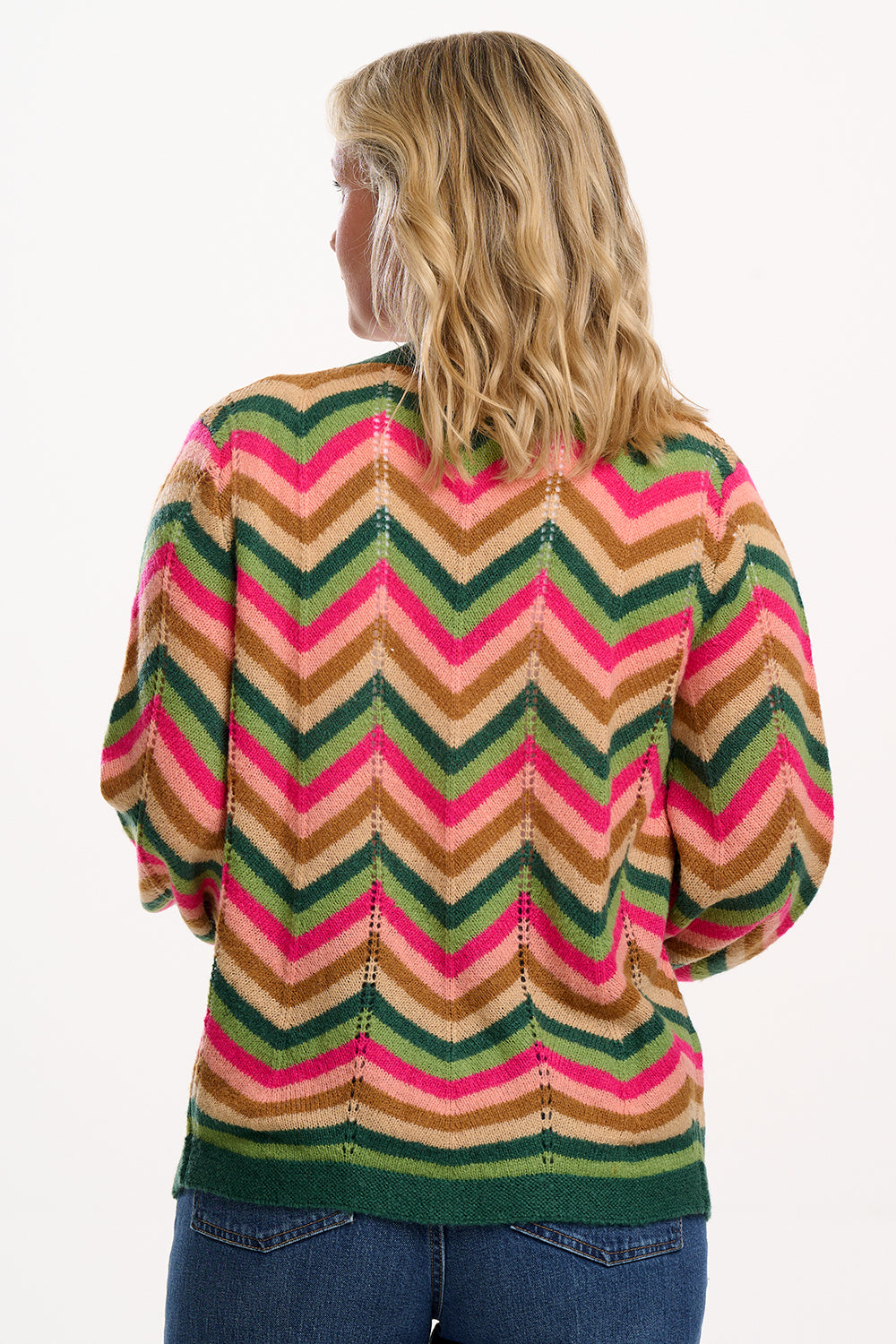 Suagrhill Brighton model wearing a colorful striped sweater with a white background