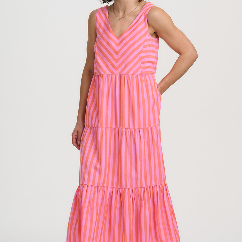 Woman wearing a pink striped dress on a white background