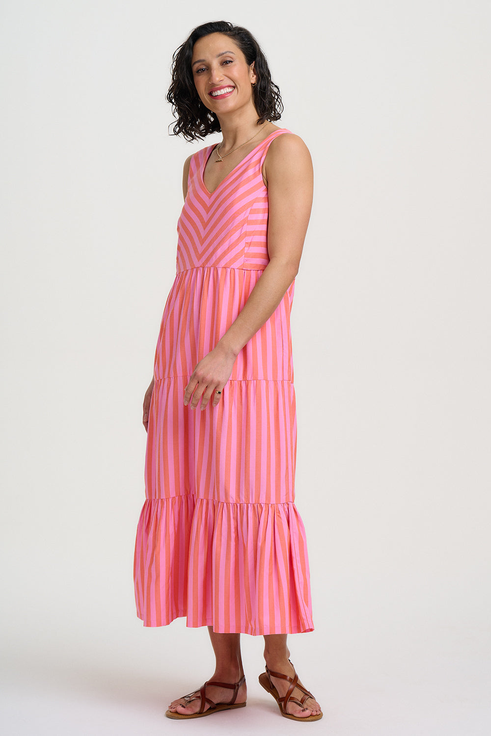 Woman wearing a pink striped dress on a white background