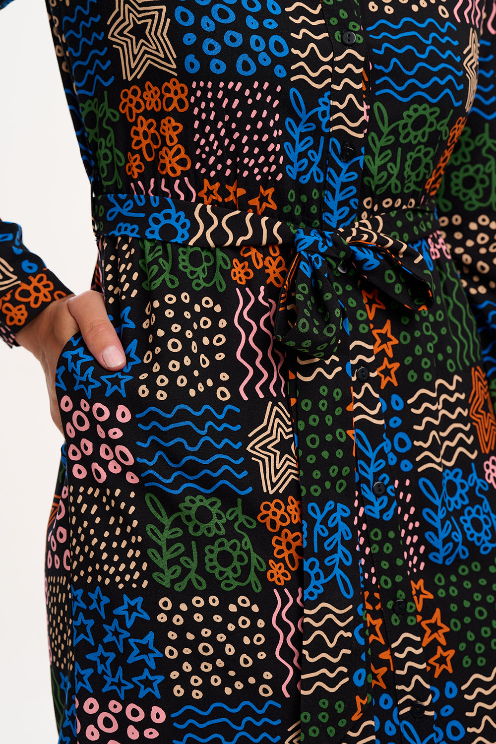 Colorful patterned fabric with abstract designs on a plain background