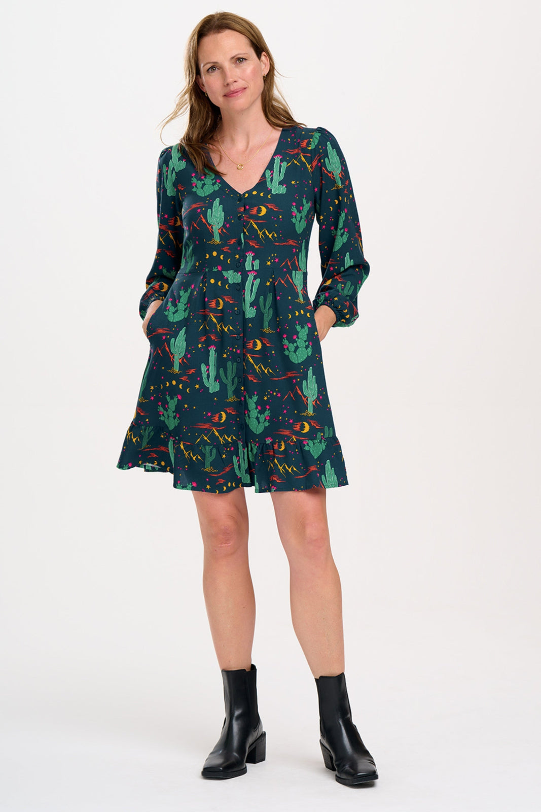 Woman wearing a patterned dress on a white background