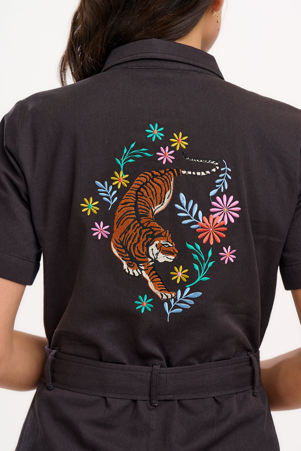A black boilersuit with half-sleeve shirt top and straight legs, featuring a floral and tiger embroidery on the back.