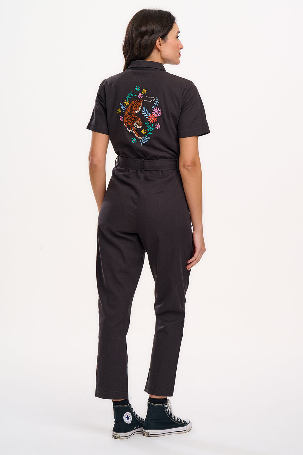 A black boilersuit with half-sleeve shirt top and straight legs, featuring a floral and tiger embroidery on the back.