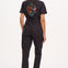 A black boilersuit with half-sleeve shirt top and straight legs, featuring a floral and tiger embroidery on the back.