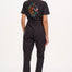 A black boilersuit with half-sleeve shirt top and straight legs, featuring a floral and tiger embroidery on the back.