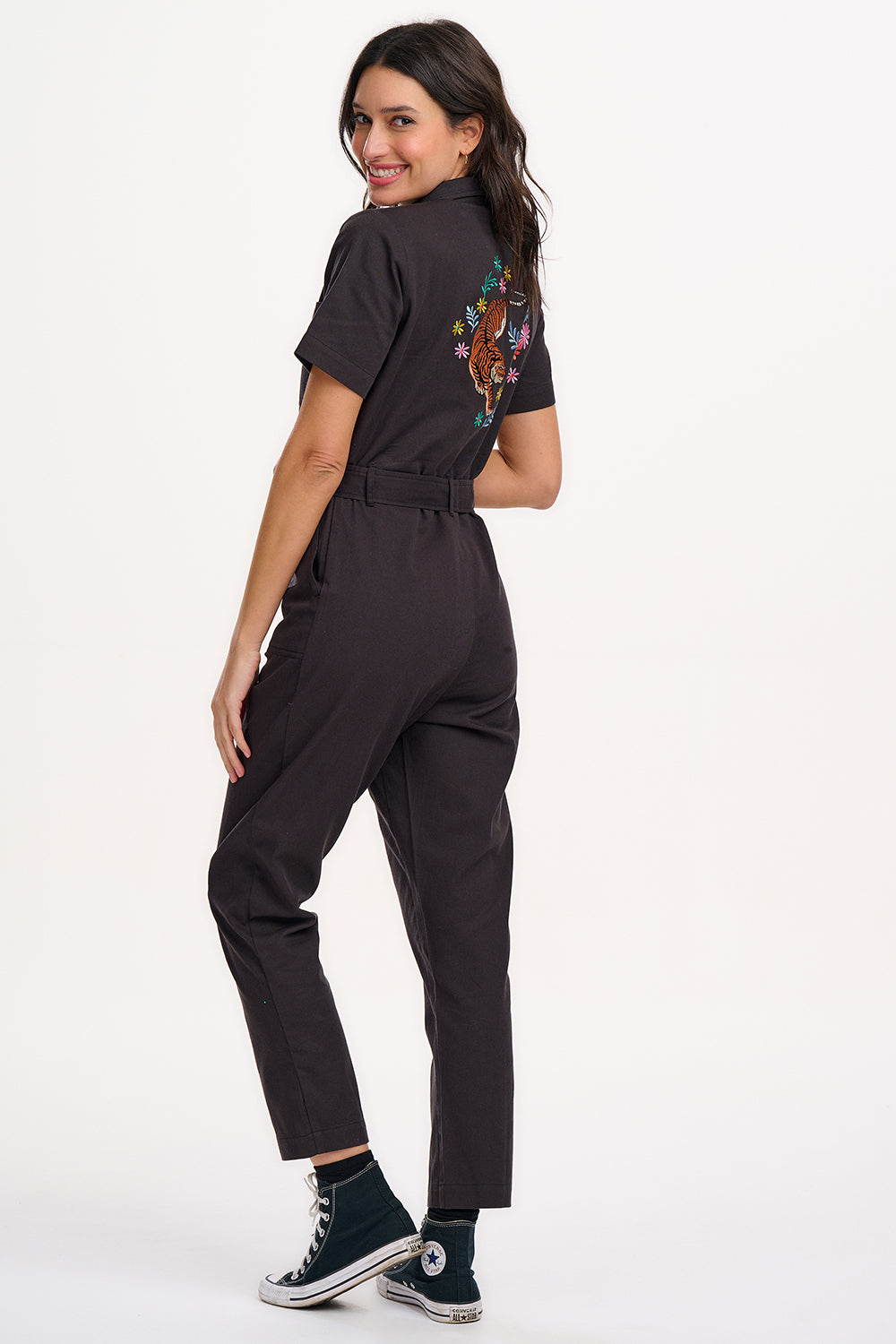 A black boilersuit with half-sleeve shirt top and straight legs, featuring a floral and tiger embroidery on the back.