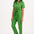 A model wearing a green boilersuit with rainbow flower embroidery on the chest pocket, featuring a half sleeve shirt upper, straight legs, and an exposed front zip.