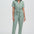 Woman wearing a light green jumpsuit on a white background