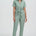 Woman wearing a light green jumpsuit on a white background