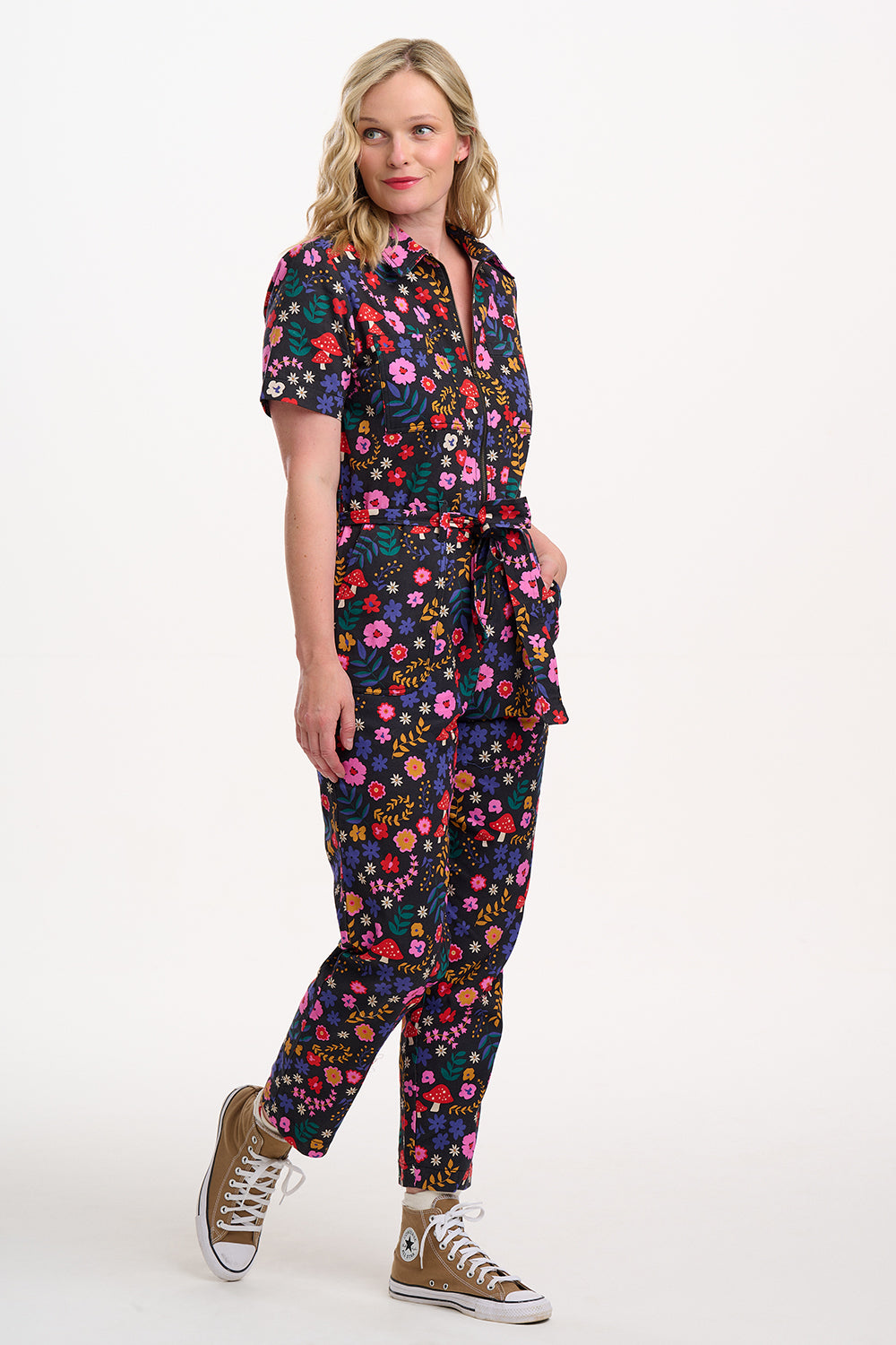 Sugarhill Brighton model wearing a colourful floral jumpsuit on a white background