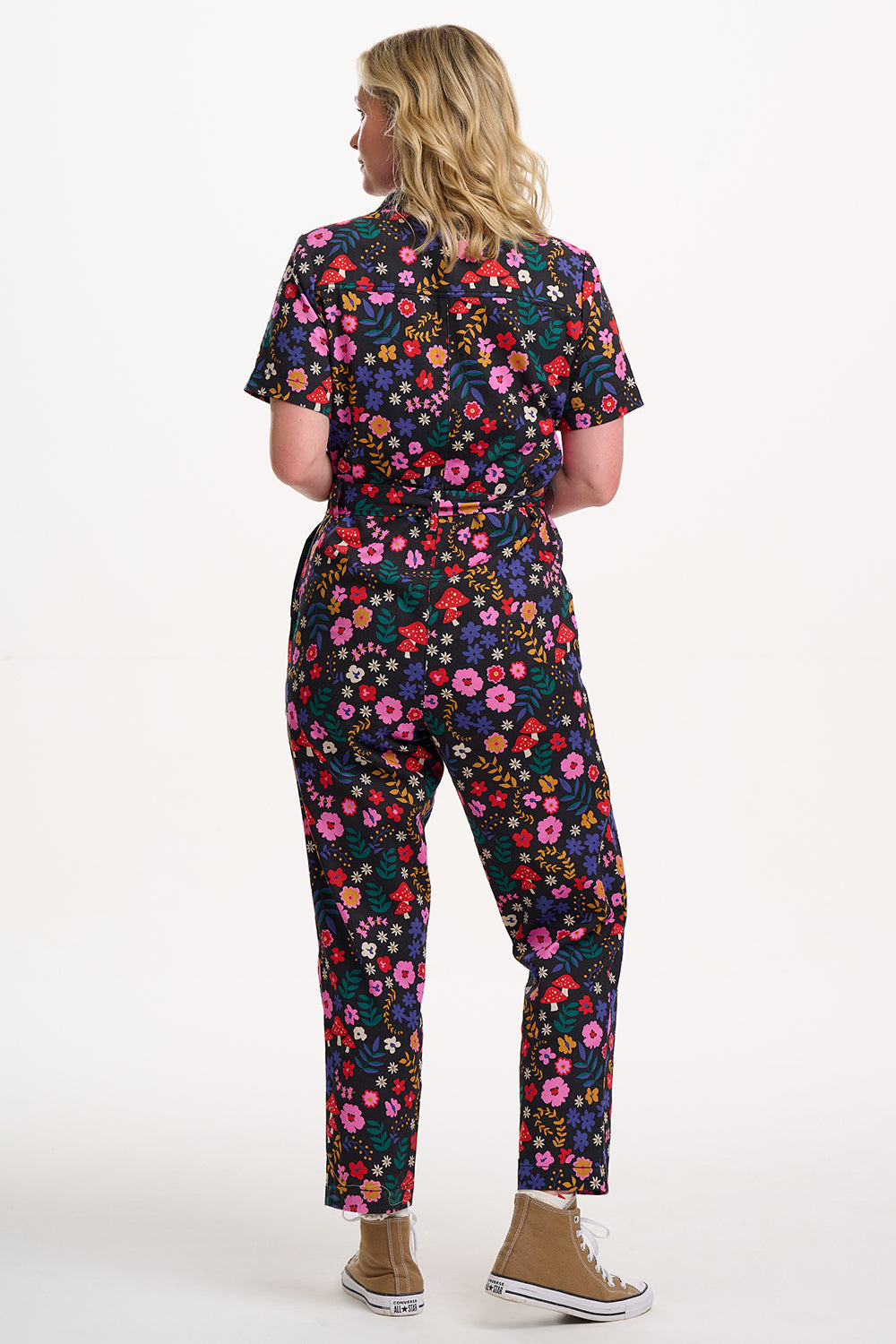 Sugarhill brighton model wearing a colourful floral jumpsuit on a white background