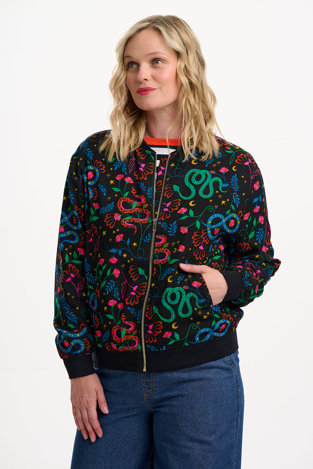 Woman wearing a colorful patterned jacket on a white background