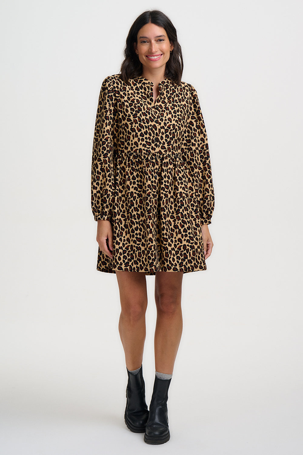 Woman wearing a leopard print dress on a white background