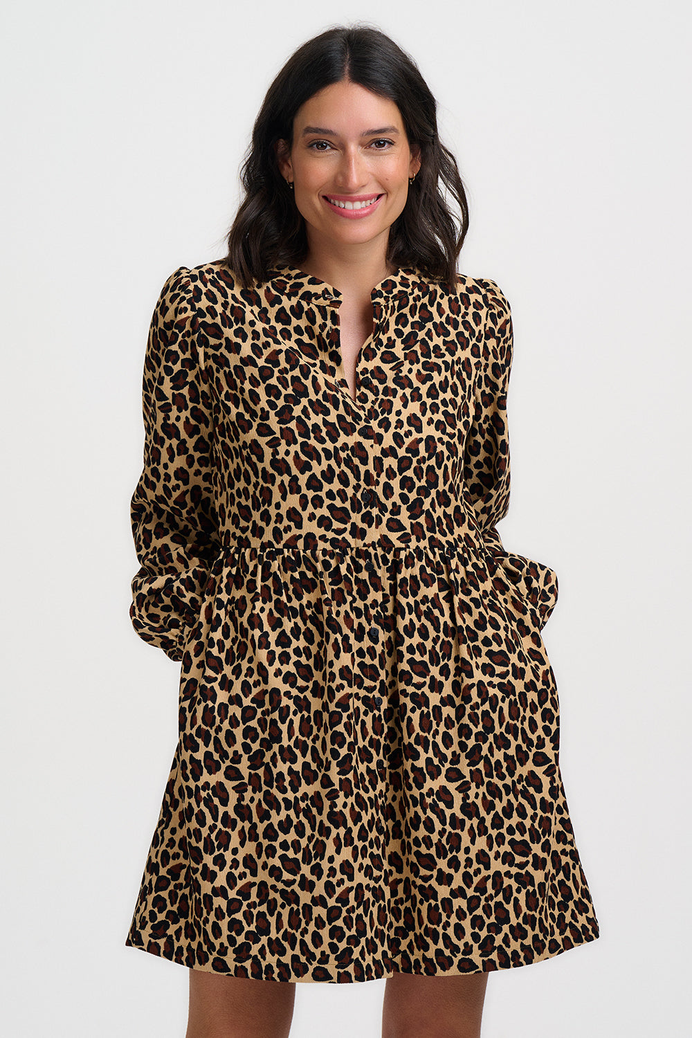 Woman wearing a leopard print dress on a white background