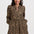 Woman wearing a leopard print dress on a white background