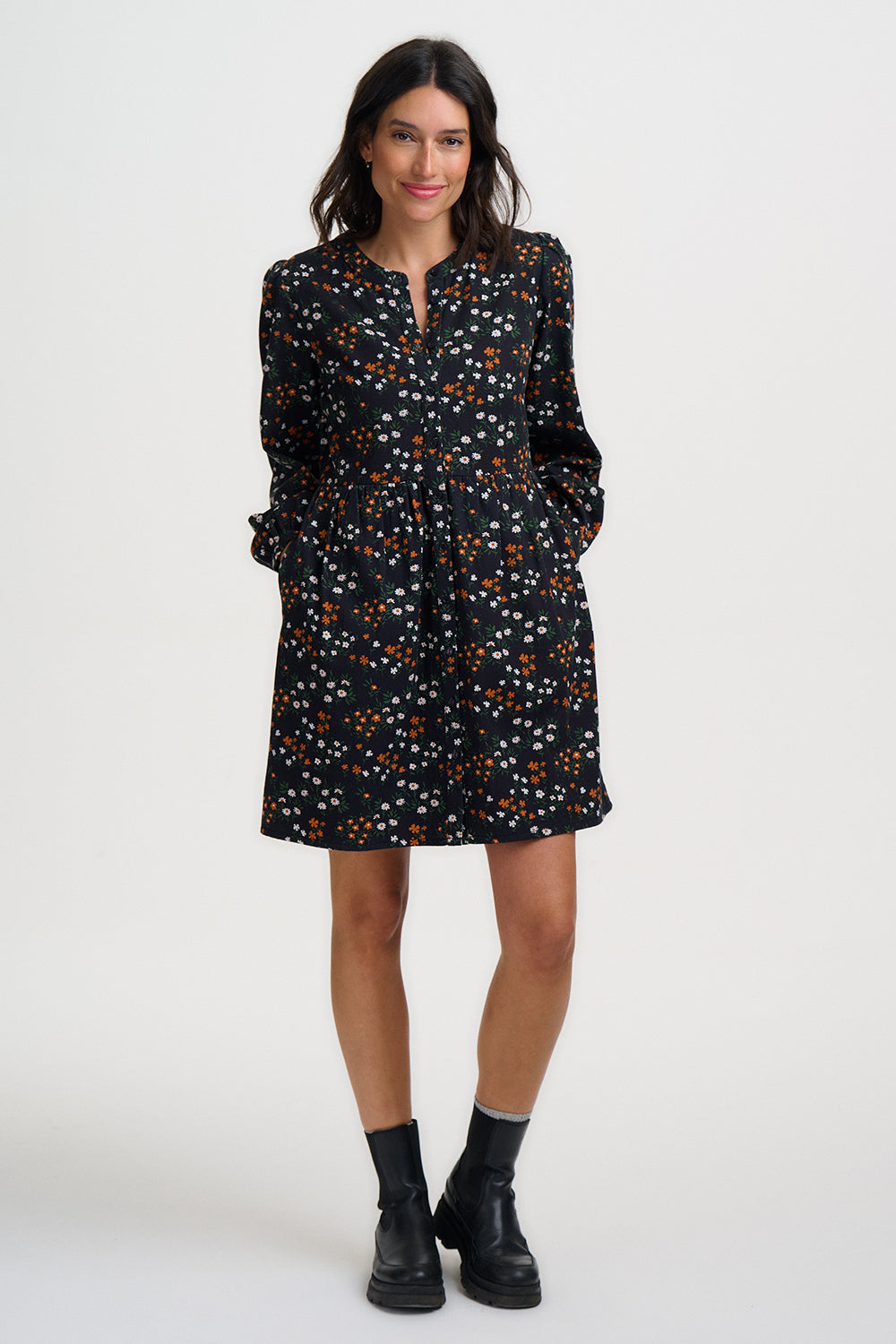 Woman wearing a black floral dress on a white background