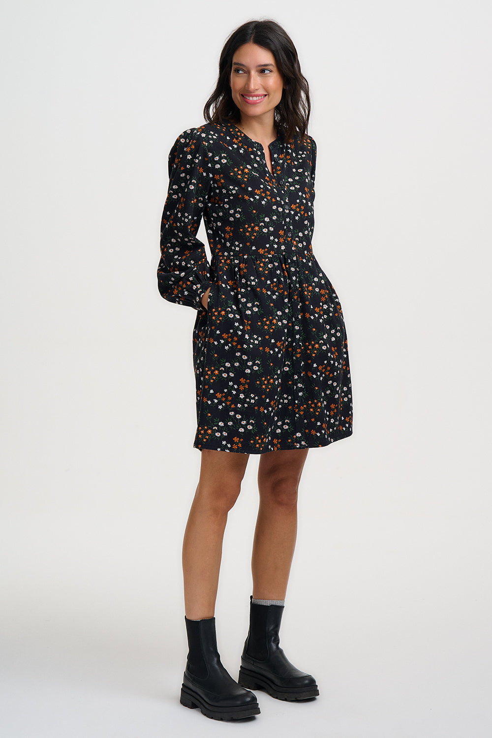 Woman wearing a black floral dress on a white background