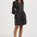 Woman wearing a black floral dress on a white background