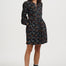 Woman wearing a black floral dress on a white background