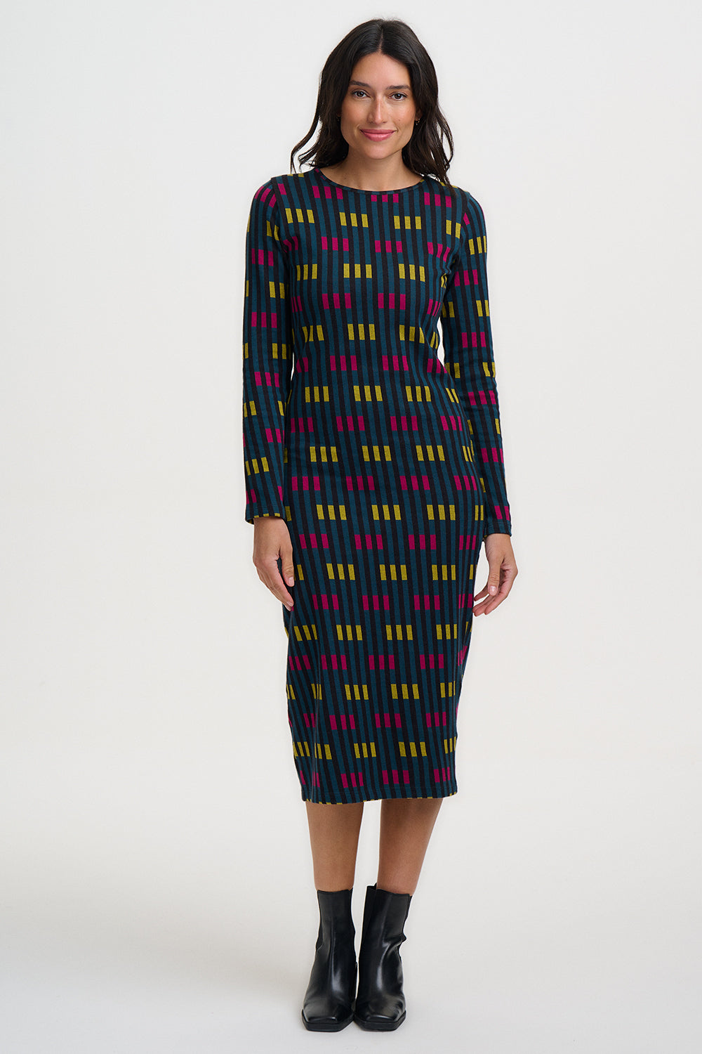 Woman wearing a patterned dress on a white background