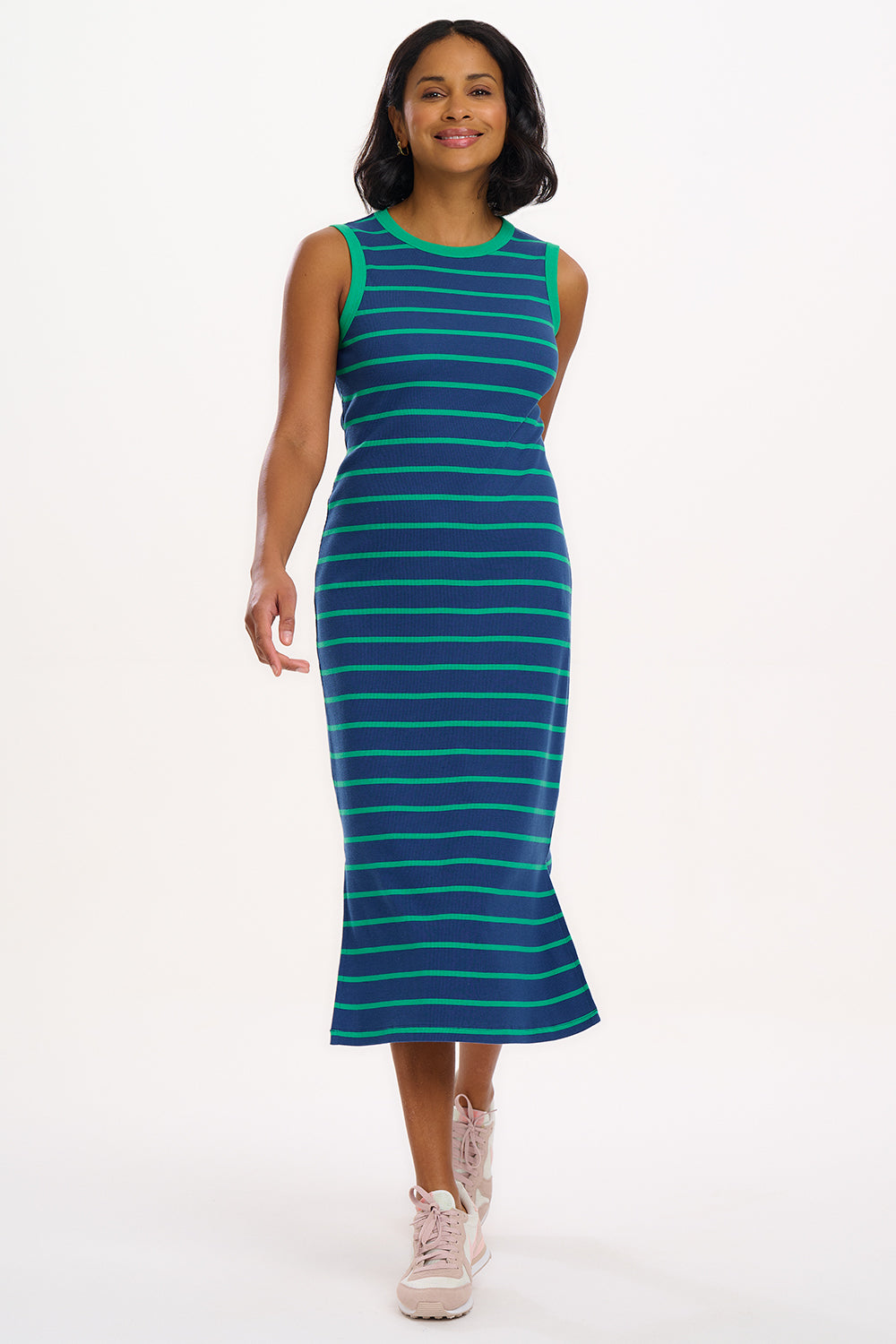 A model wearing a sleeveless, round neckline jersey dress with blue and green stripes.
