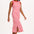 A model wearing a sleeveless, striped midi jersey dress in pink and red.