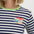 Navy and white striped shirt with colorful book design on a plain background