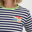 Navy and white striped shirt with colorful book design on a plain background