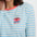 Woman wearing a blue and white striped shirt with a coffee-themed design.