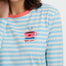 Woman wearing a blue and white striped shirt with a coffee-themed design.