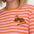 Person wearing a pink and orange striped shirt with a tiger design.