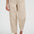 Person wearing beige pants and brown sandals on a white background