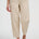 Person wearing beige pants and brown sandals on a white background
