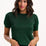 Woman wearing a green sweater against a white background