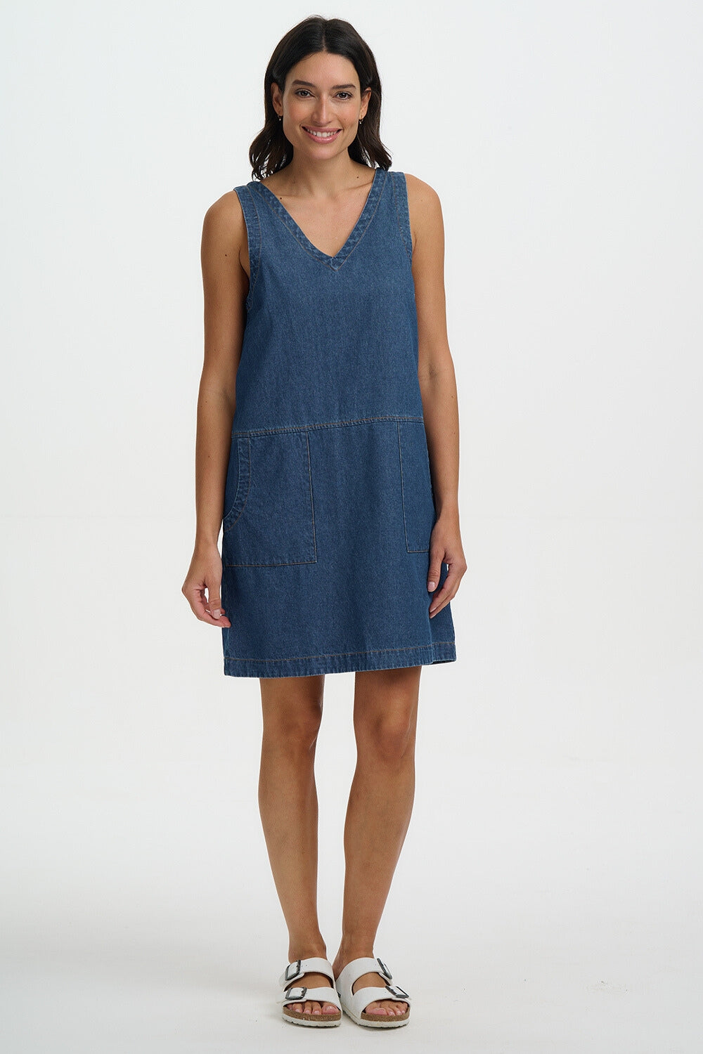 Woman wearing a blue denim dress on a white background