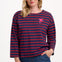 Sugarhill Brighton model wearing a red and blue striped shirt with a small design on a plain background