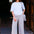 Woman wearing awhite tshirt and colorful striped pants