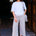 Woman wearing awhite tshirt and colorful striped pants