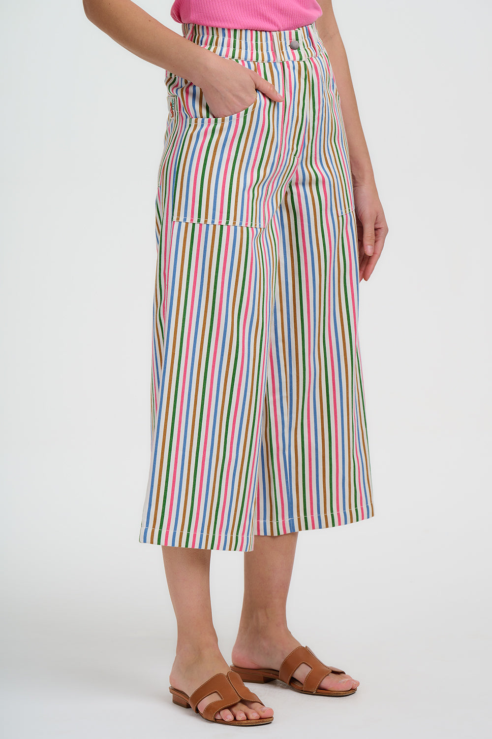 Person wearing a colorful striped skirt on a white background