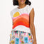 Woman wearing a colorful sleeveless top and patterned shorts on a white background