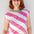 Woman wearing a pink and white striped sleeveless top against a light background
